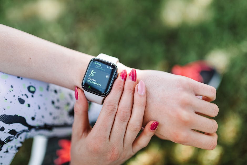 Close-up of a woman using a fitness tracking smartwatch during exercise outdoors.