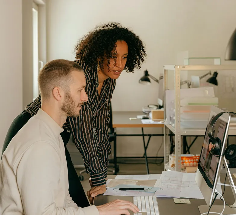 2 people doing something in a computer
