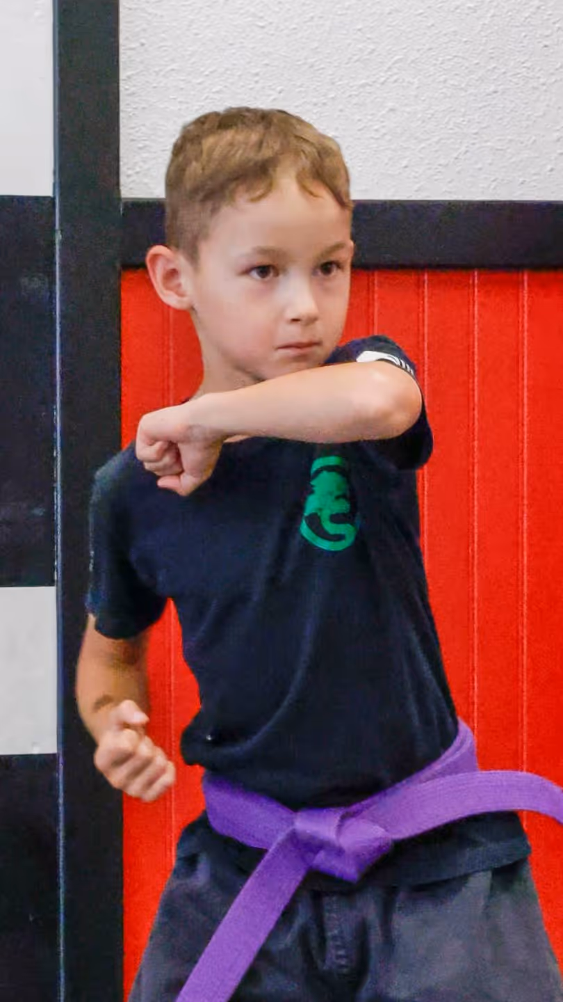 A USSD Livermore Kids Karate Class student practicing blocks.