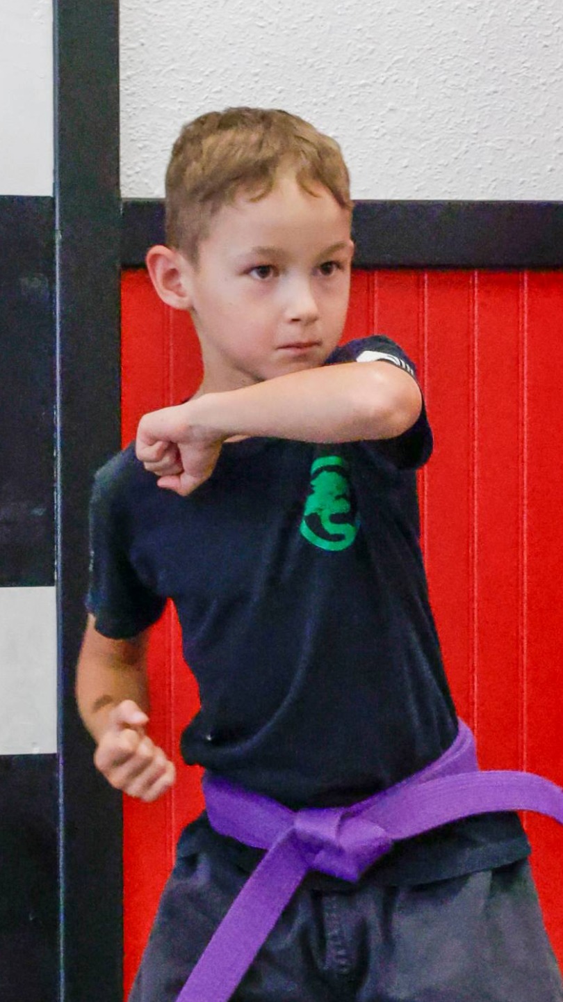 A USSD Livermore Kids Karate Class student practicing blocks.