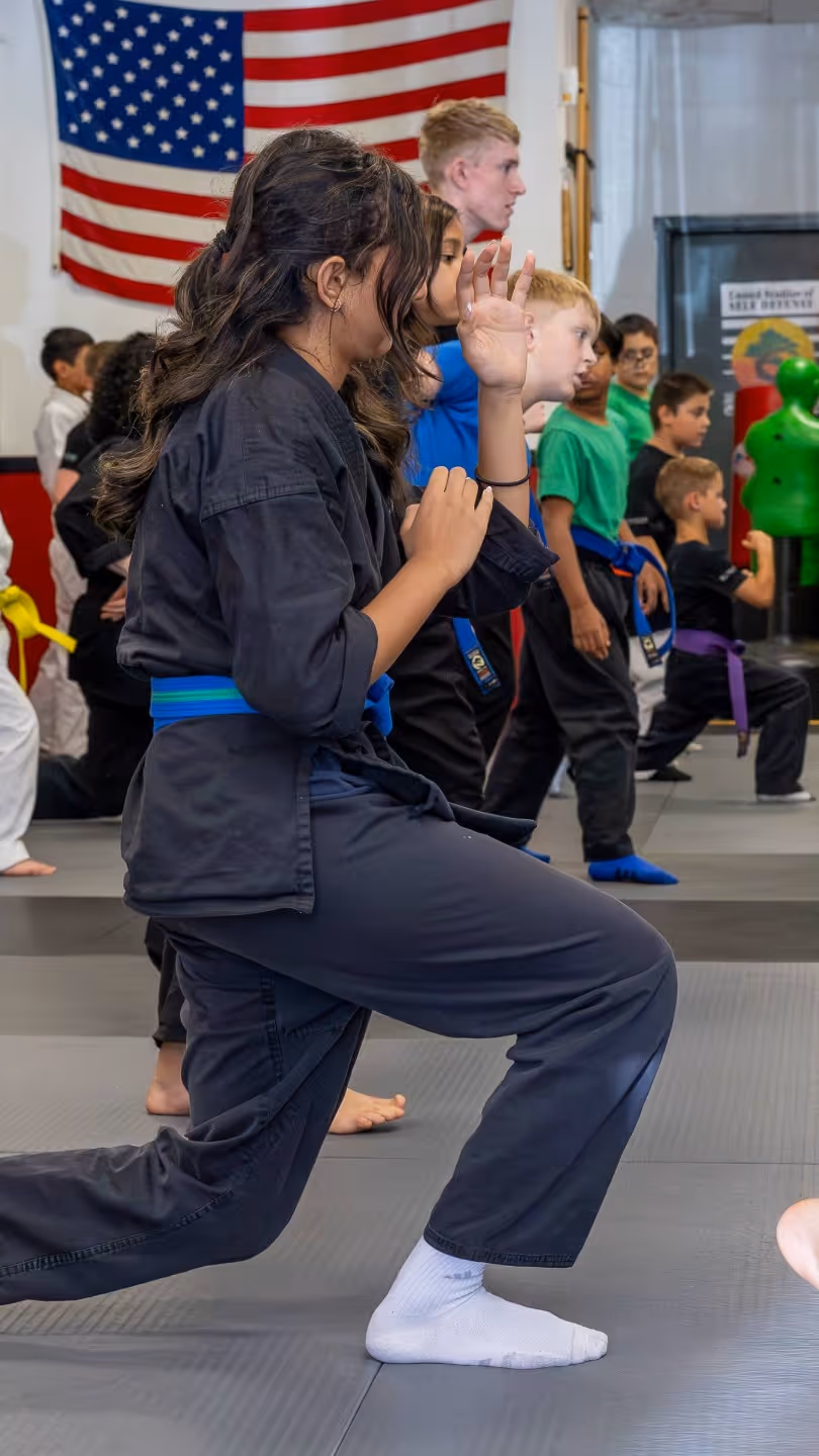 USSD Livermore Teens and Kids Karate classes warm up together.