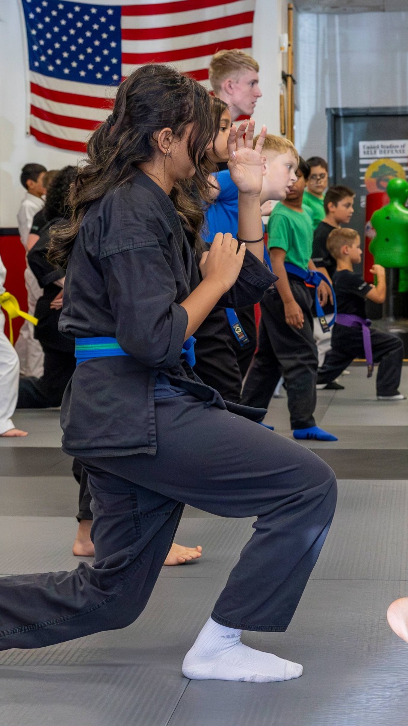 USSD Livermore Teens and Kids Karate classes warm up together.
