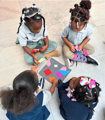 Four young students working on an art project together