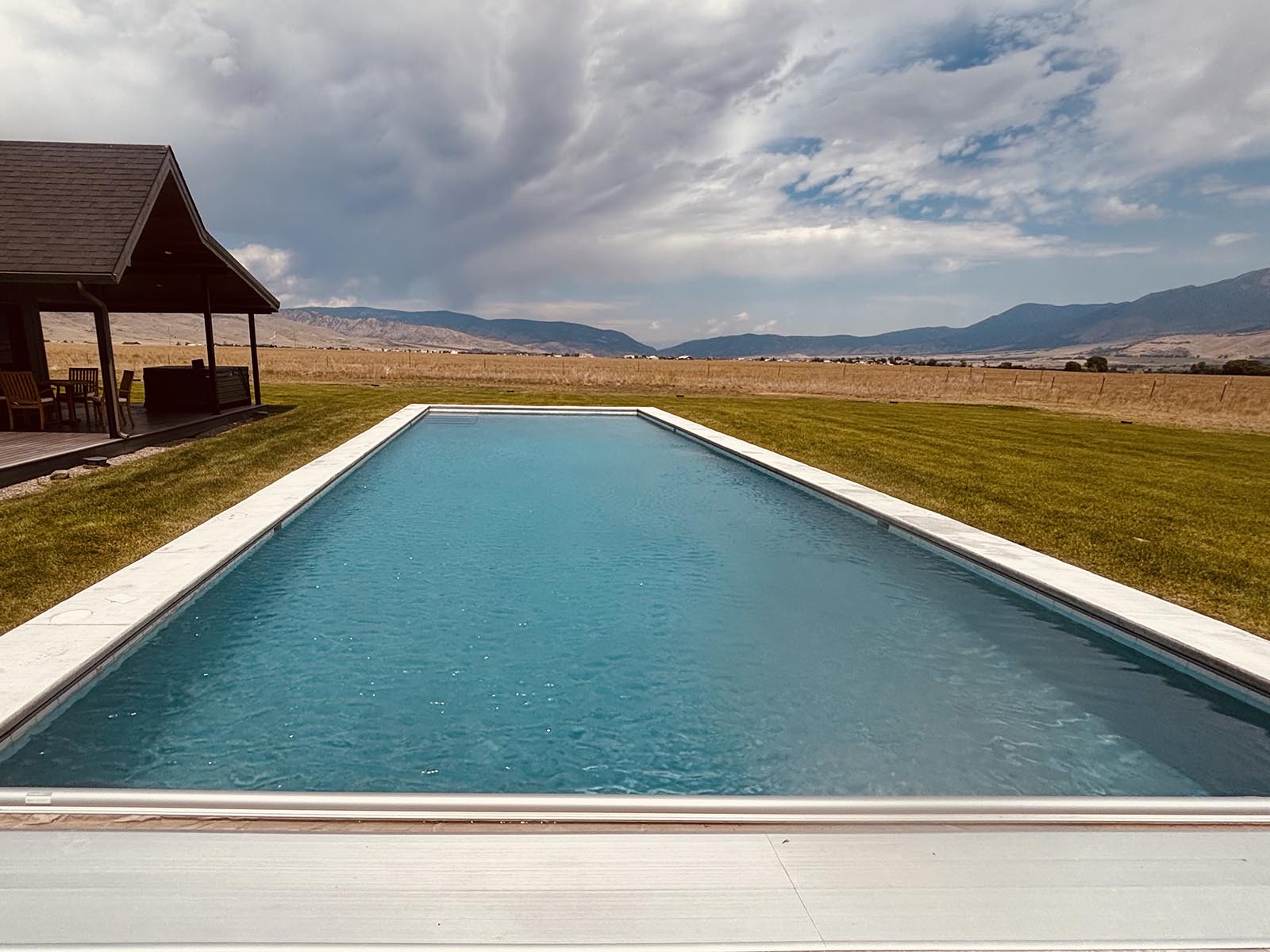 image of a large pool with home and mountain