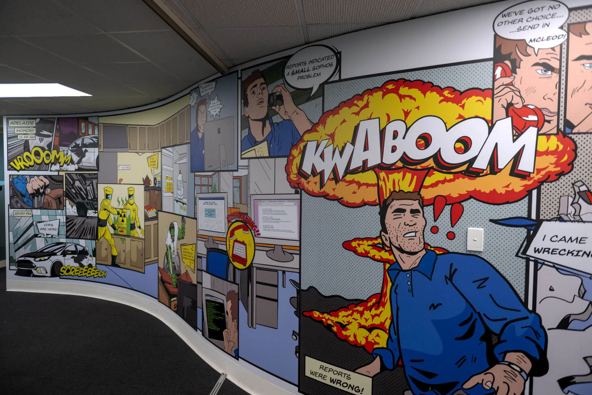 an office wall with a cartoon of a man in a blue shirt