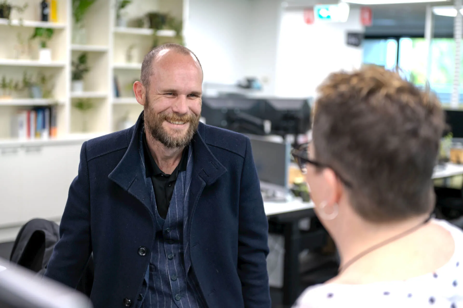 a man with a beard is talking to a woman