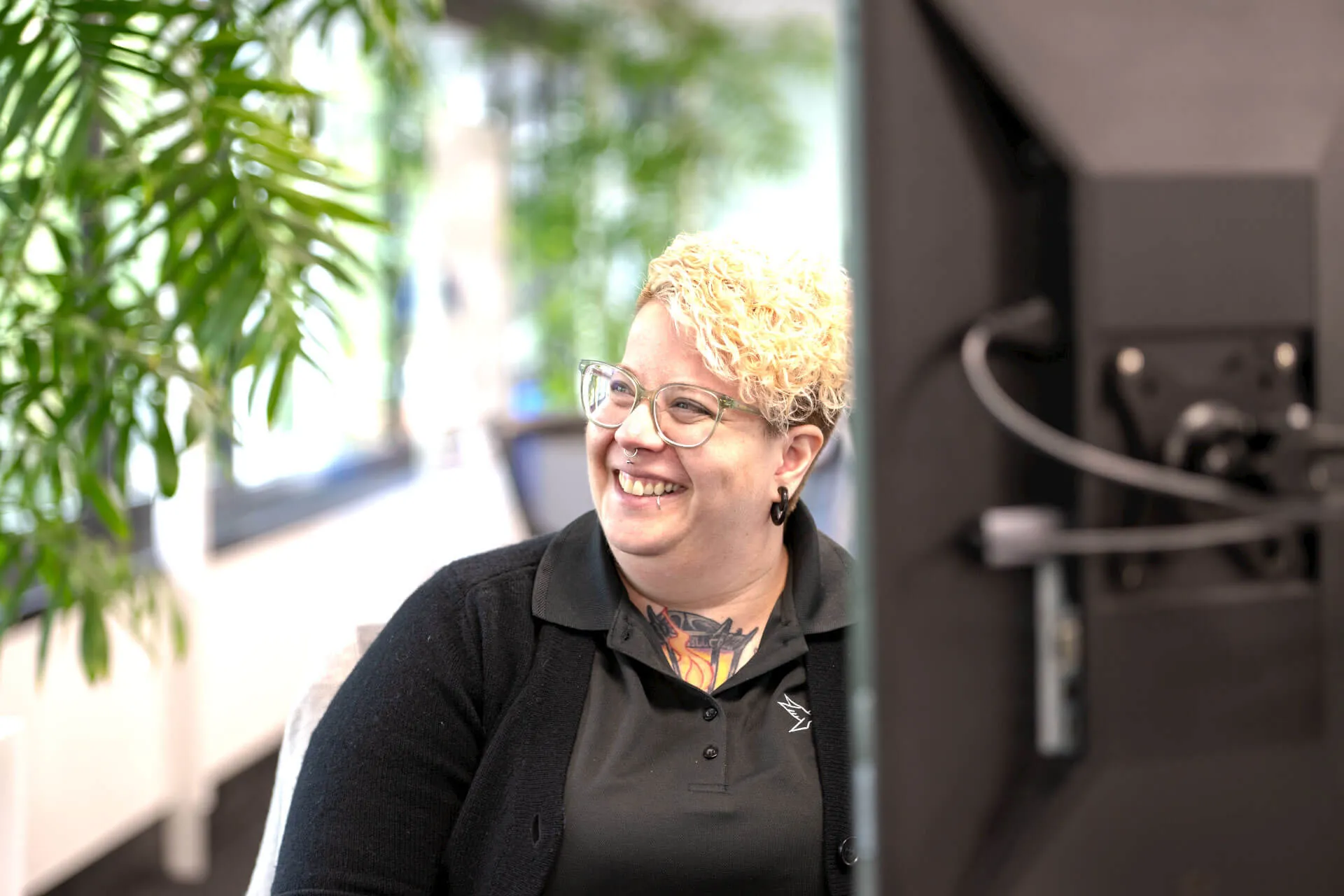 a woman in a black shirt is smiling