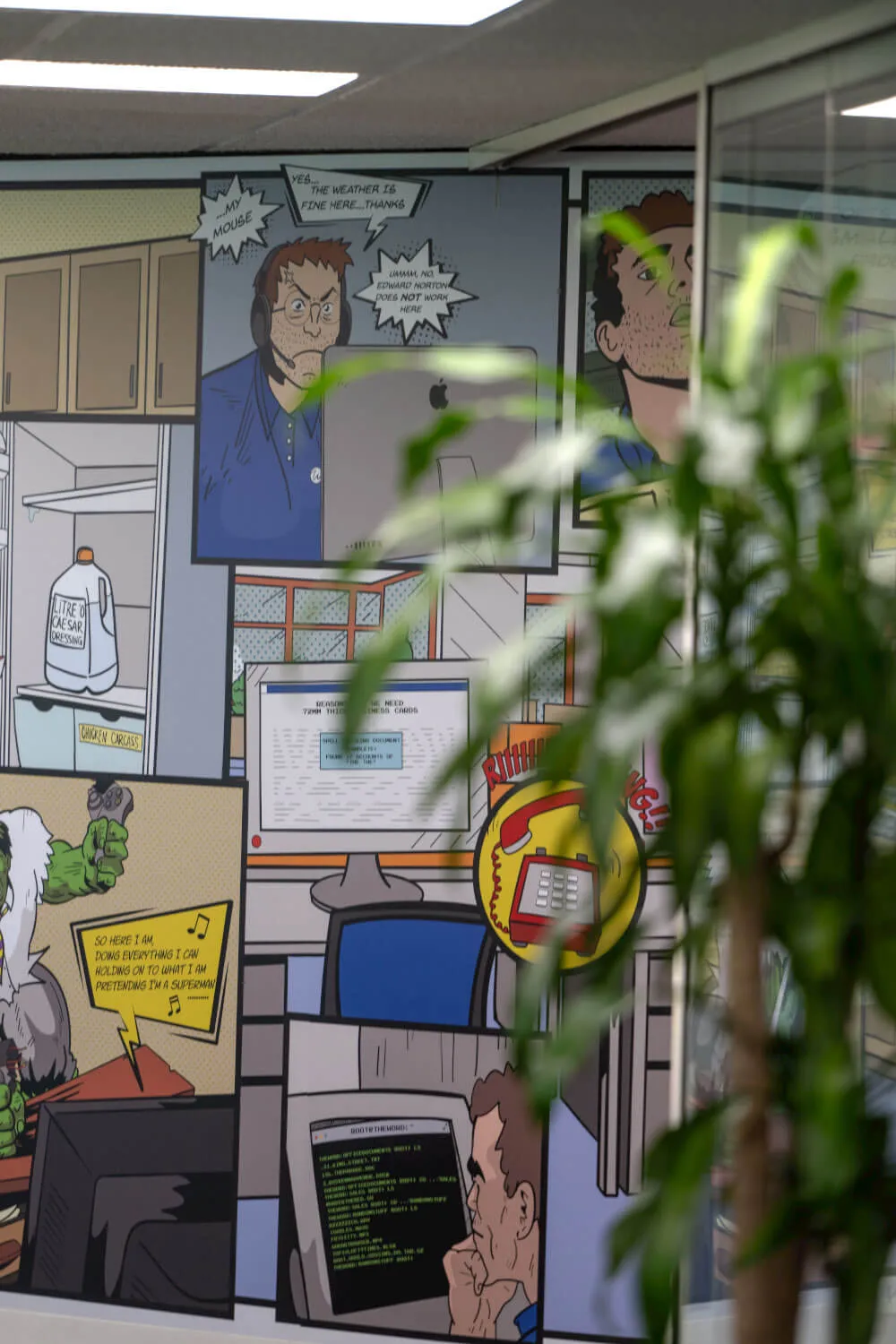 an office with a mural of a man in a blue shirt