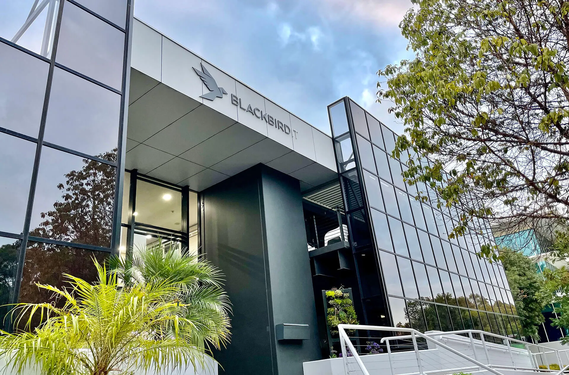the front of a building with stairs leading up to it