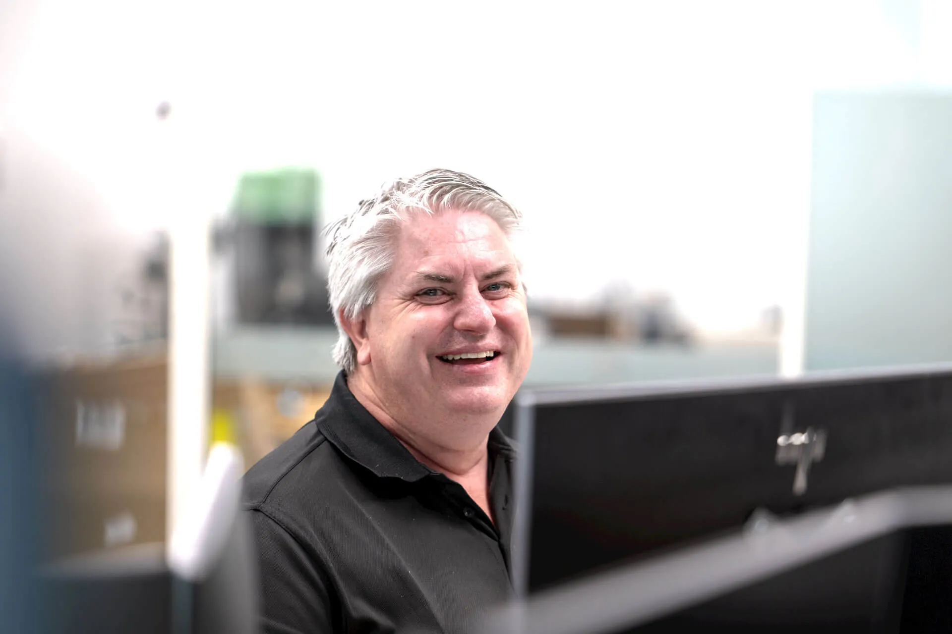a man sitting in front of a laptop computer