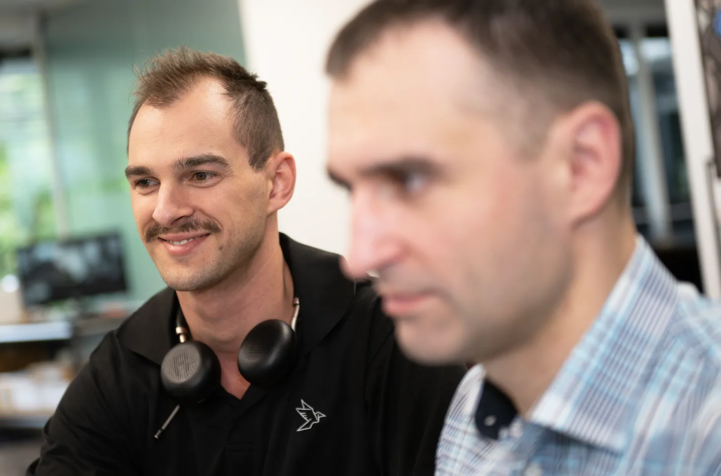 a couple of men sitting next to each other