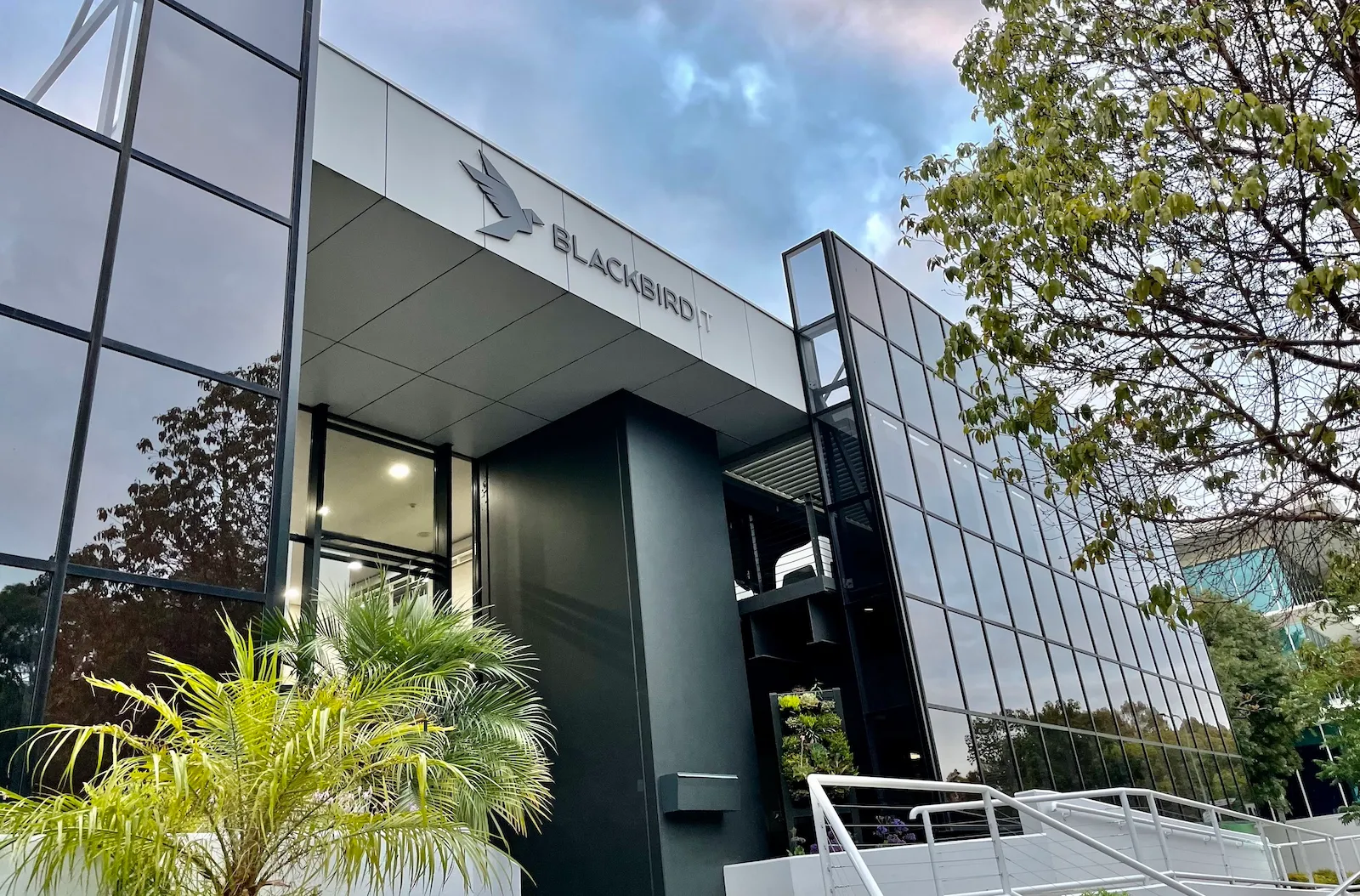 the front of a building with stairs leading up to it