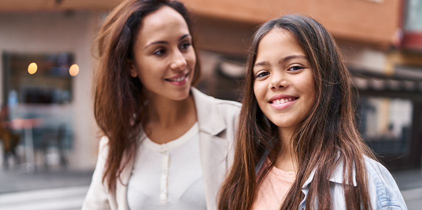 Mother and daughter walking in the city