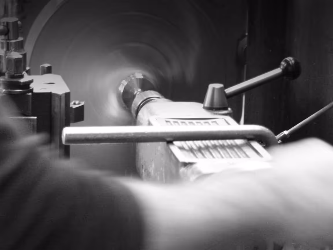 Machinist operating manual lathe on marine propeller
