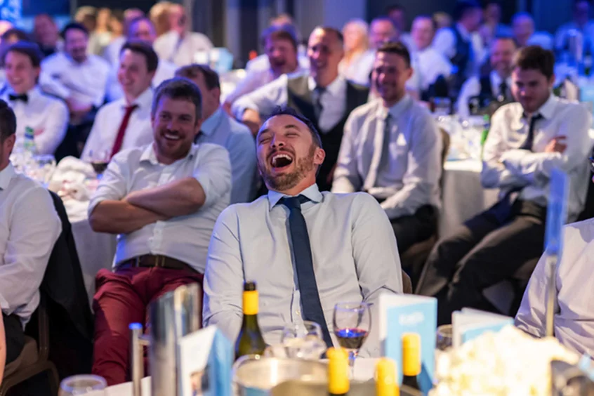 man laughing at dinner