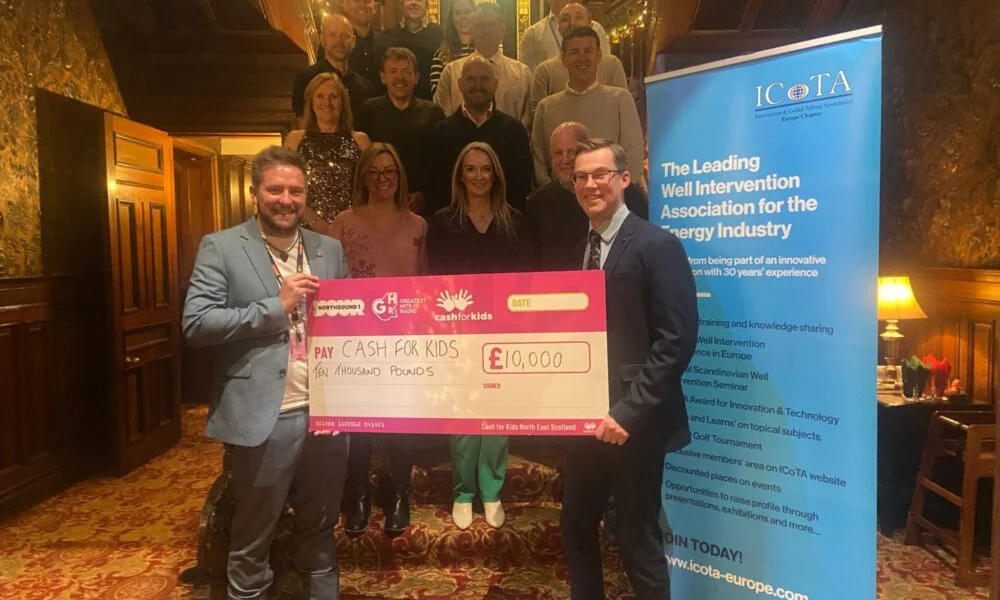 People holding large cheque