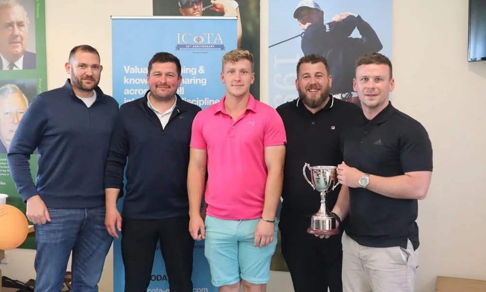 Golfers holding trophy
