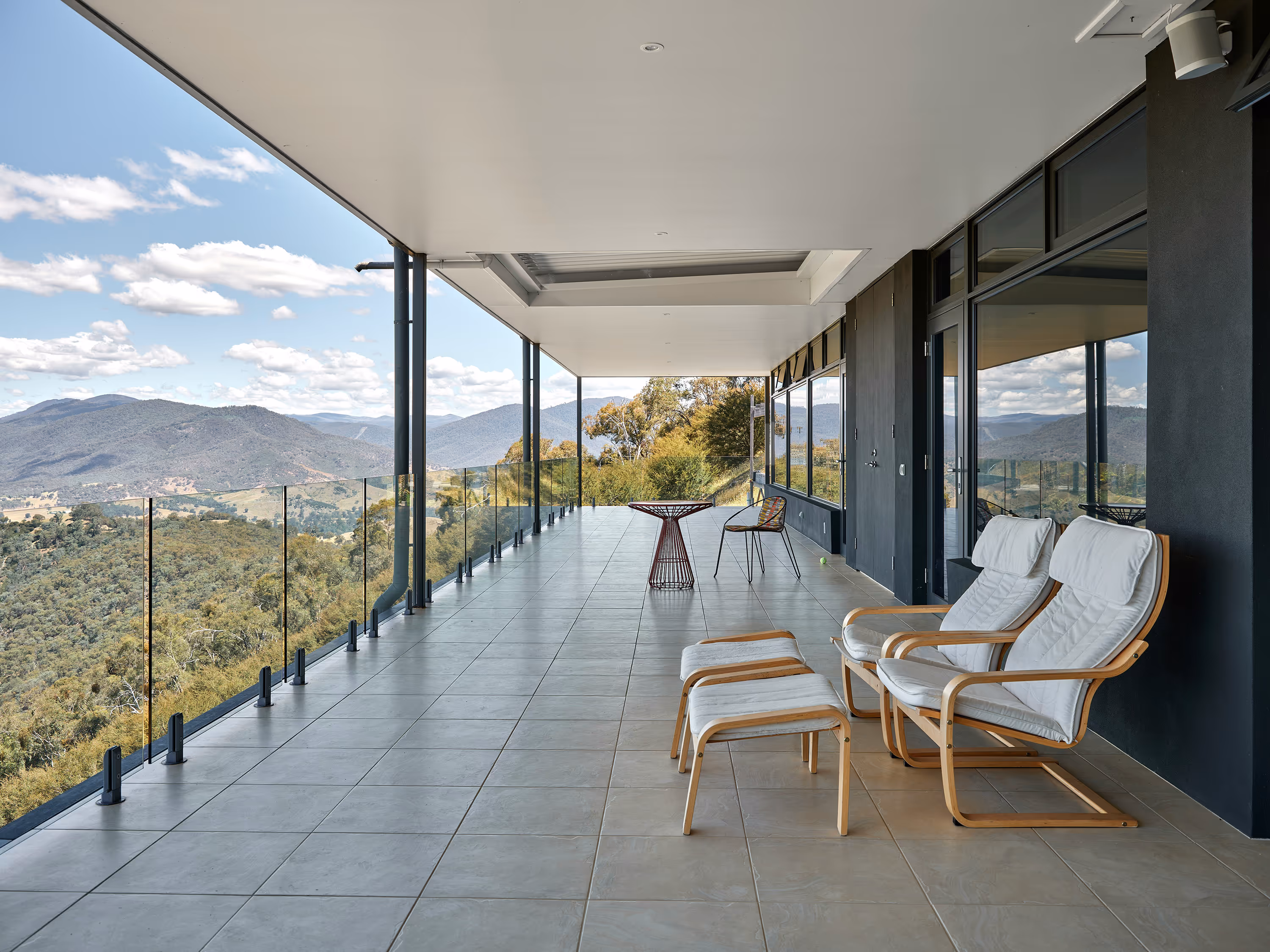 Modern balcony with mountain view and lounge chairs