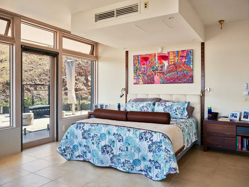 Bright bedroom with colorful bedspread and wall art