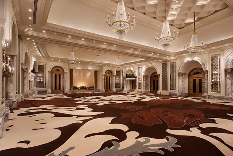 Luxury hotel ballroom with elegant chandeliers and patterned carpet