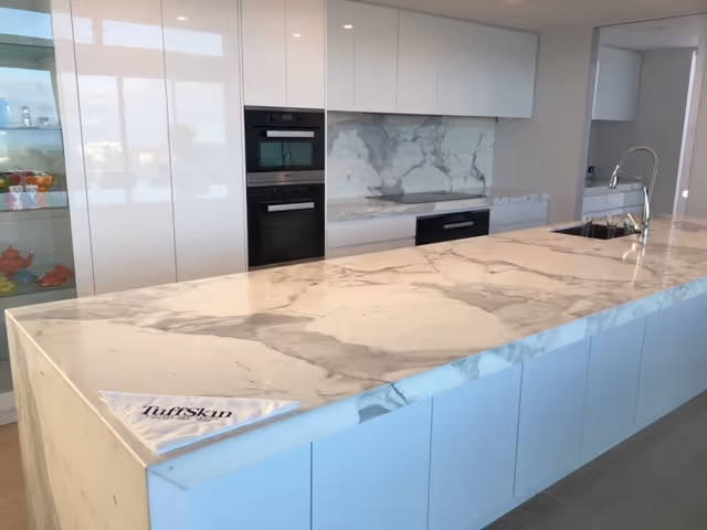 Modern kitchen with marble countertop protected by TuffSkin surface protection film, ensuring durability and stain resistance.