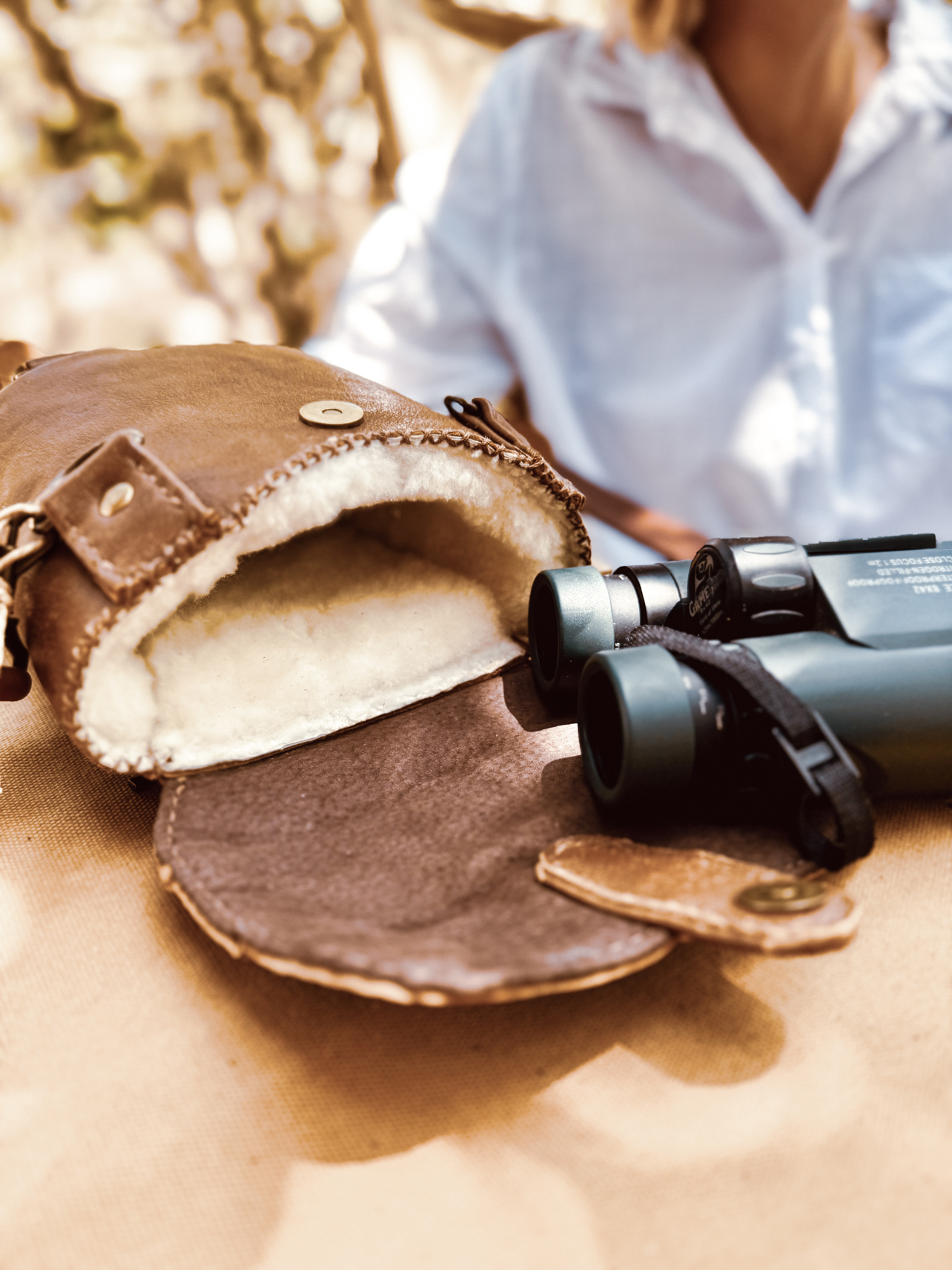 Handmade leather binocular bag with locally sourced merino wool lining