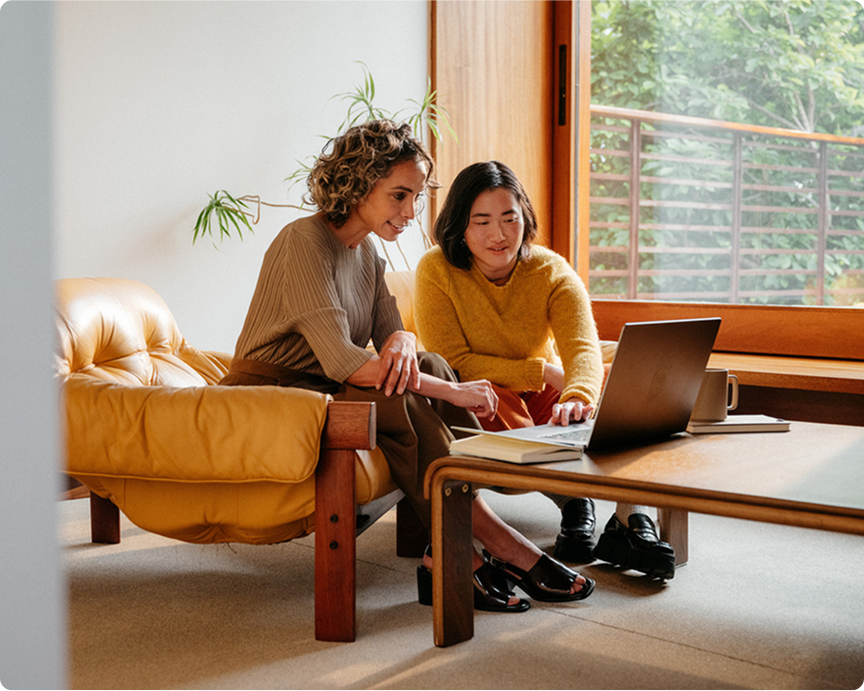 Photo of two people in call on their computer.