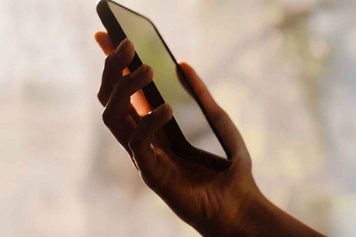 Photo of a phone holding a phone.