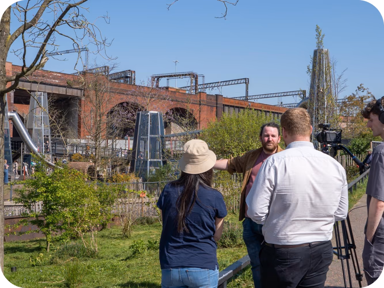 Matt, Product Manager at Massey & Harris, being interviewed at Mayfield Play Yard with film crew and production team