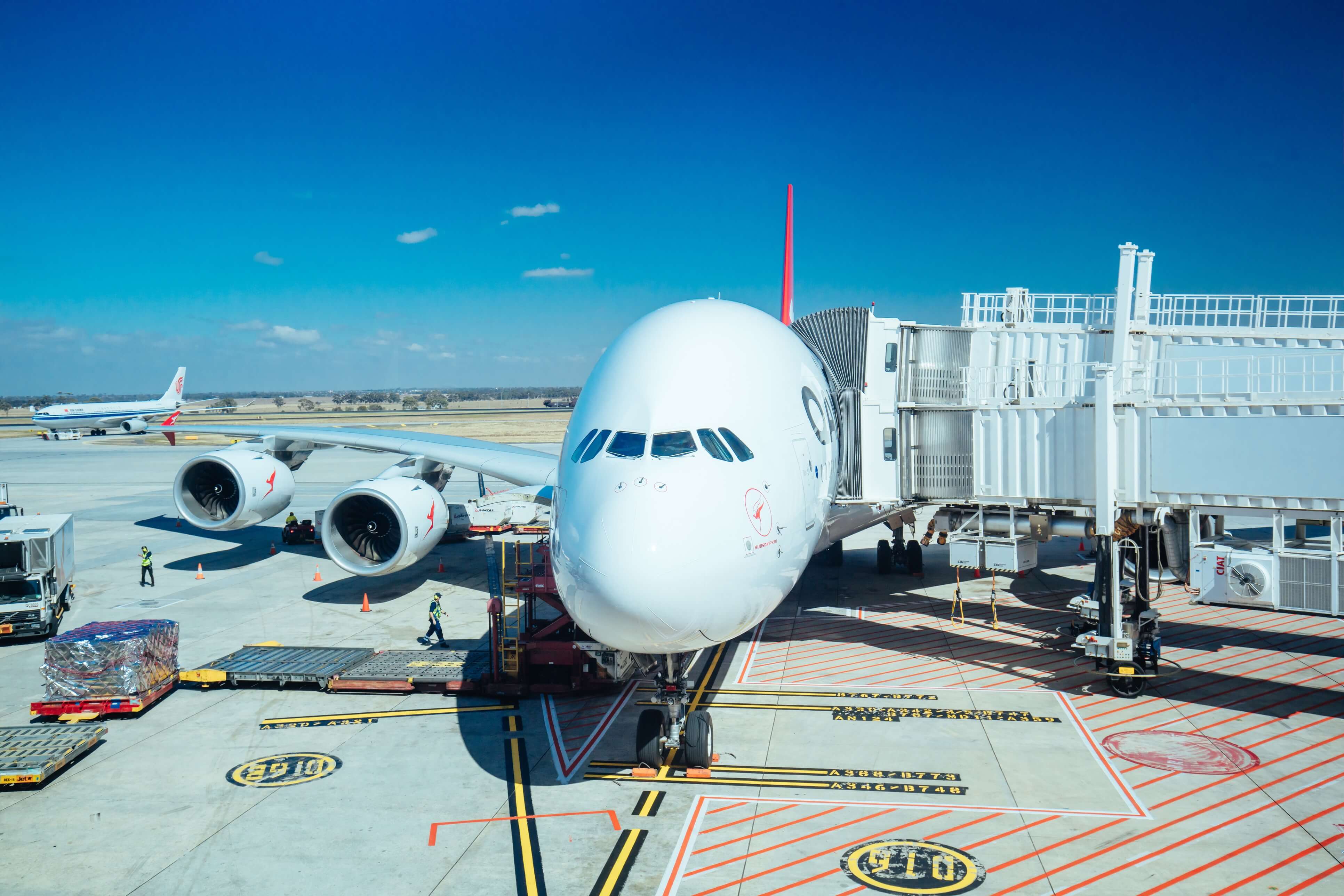 A photo of a Qantas A380 aircraft docked at an airport jetway