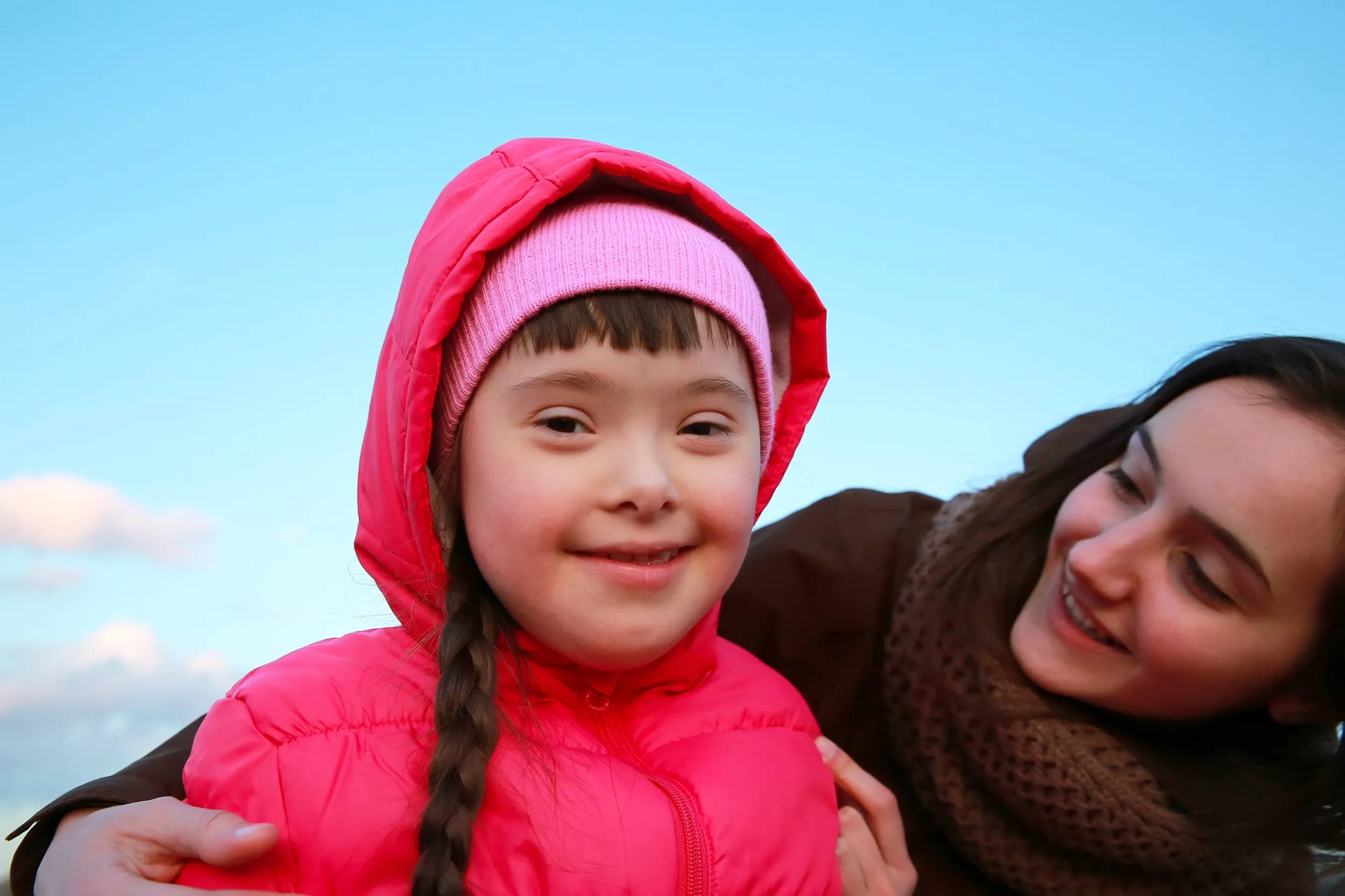 Young Down Syndrome girl smiling with Sennie