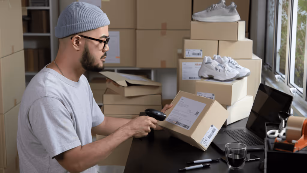 A person scanning orders to be fulfilled and shipped to customers.