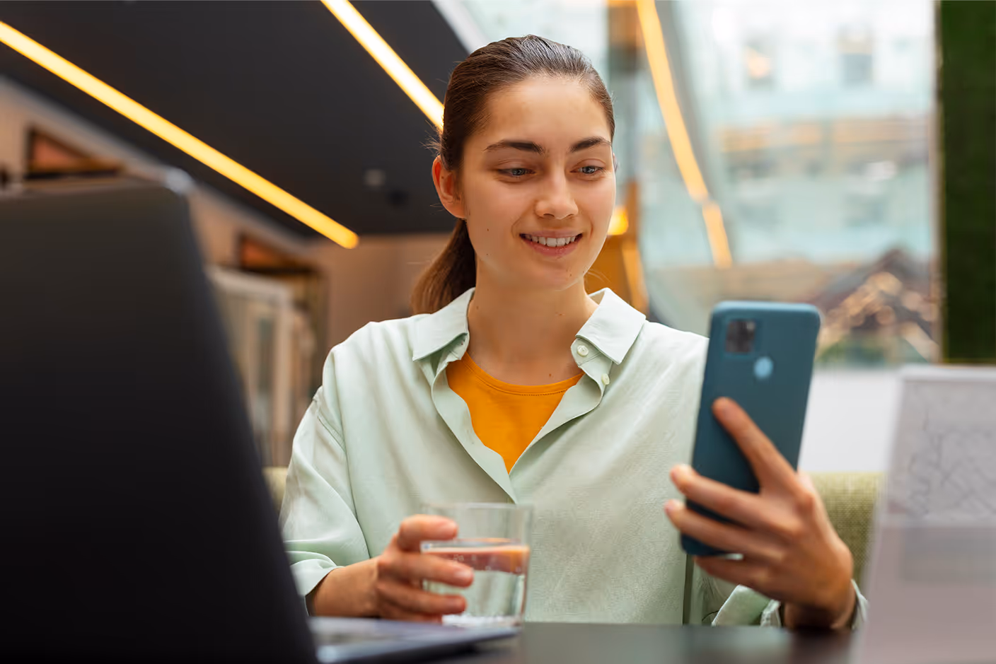 An ecommerce brand manager checking their inventory on a mobile device and laptop.