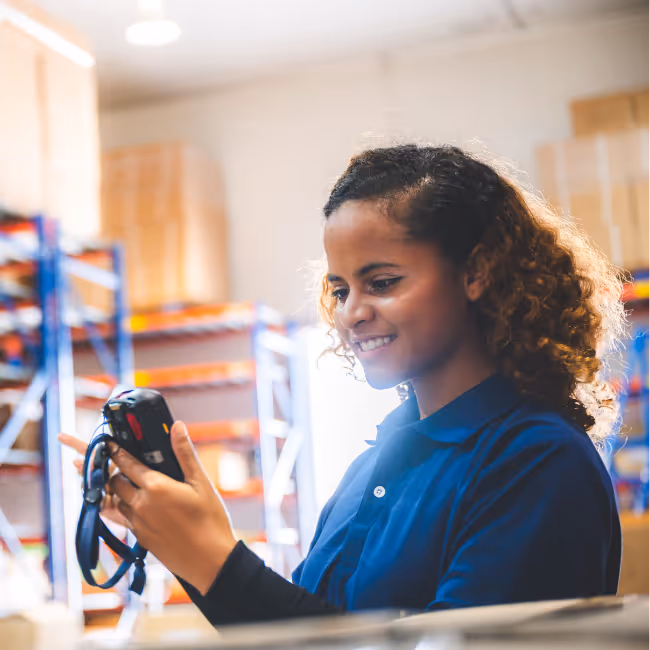A person scanning inventory on a handheld.