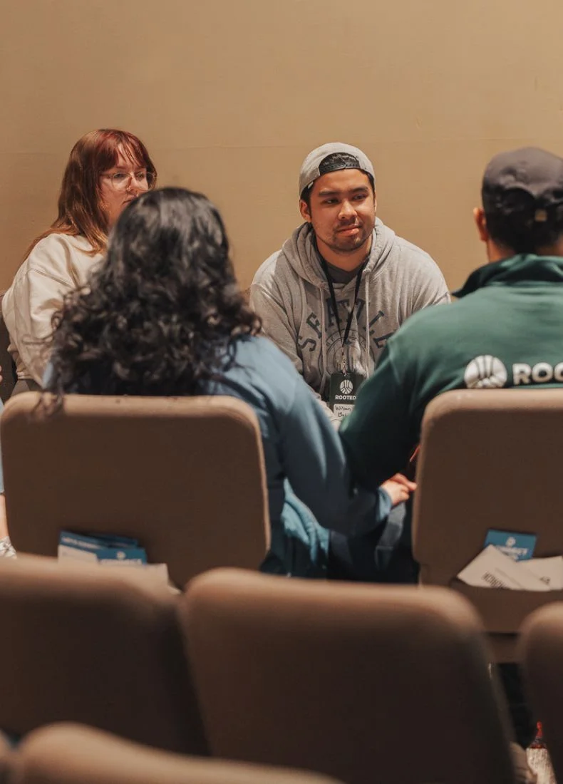 Group discussion with people sitting in conference room chairs