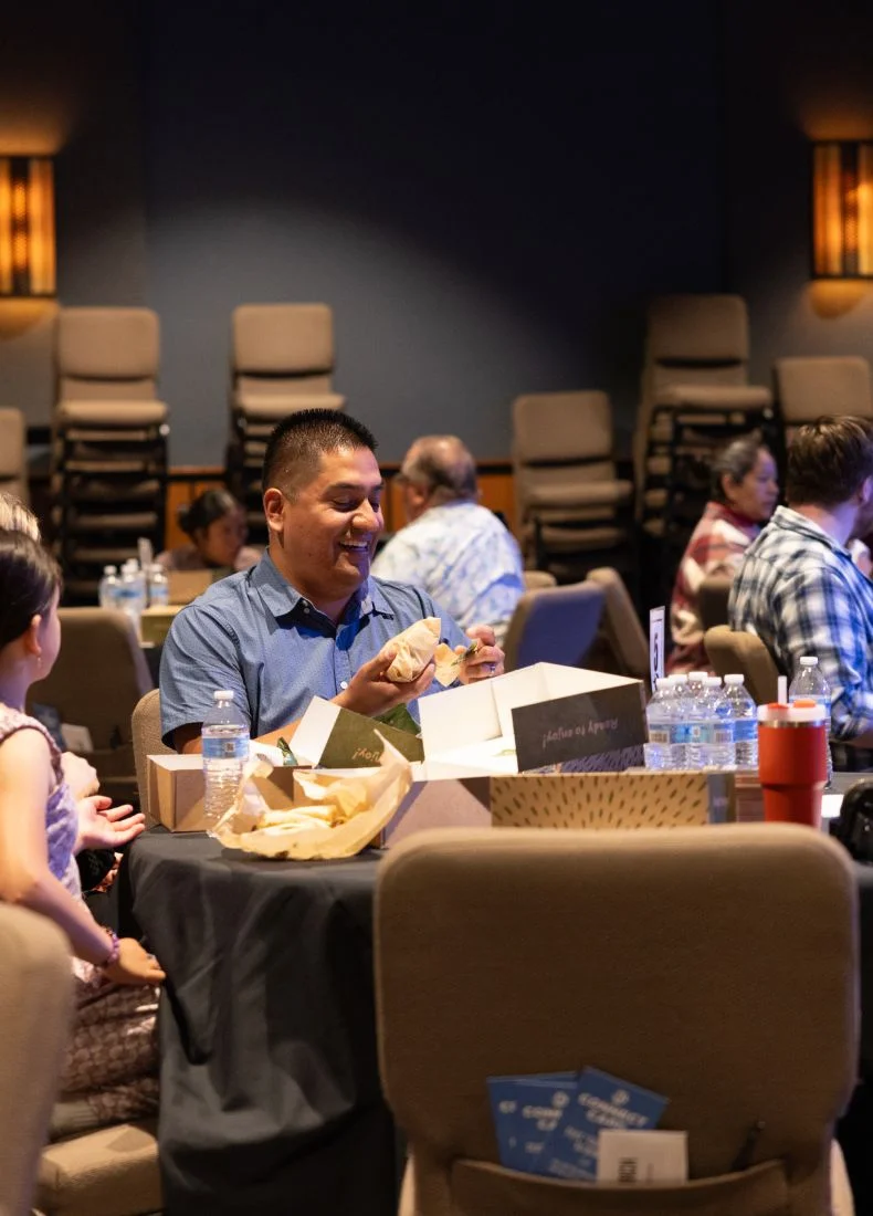 People at conference table eating lunch during professional event