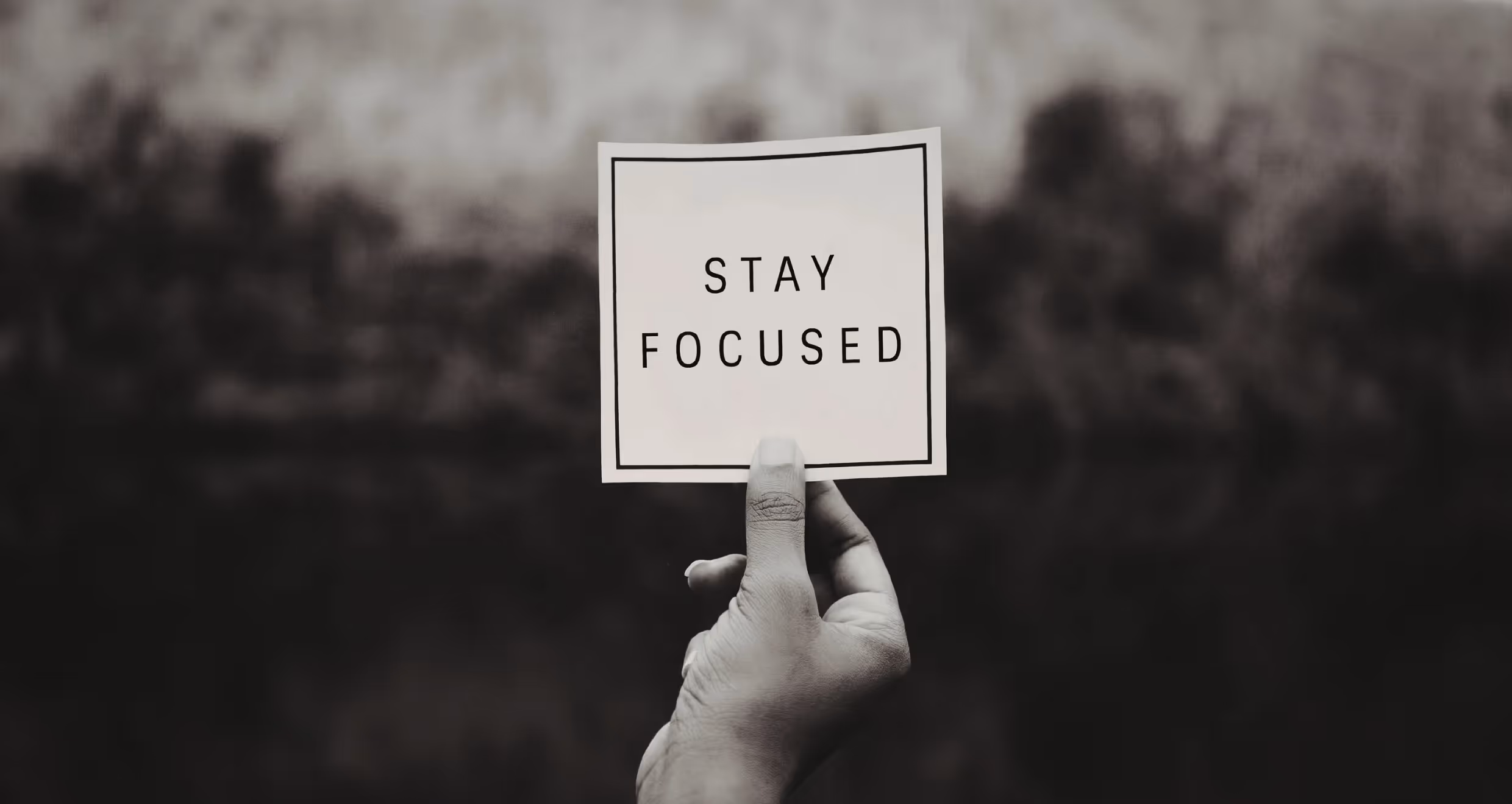 hand holding stay focused sign