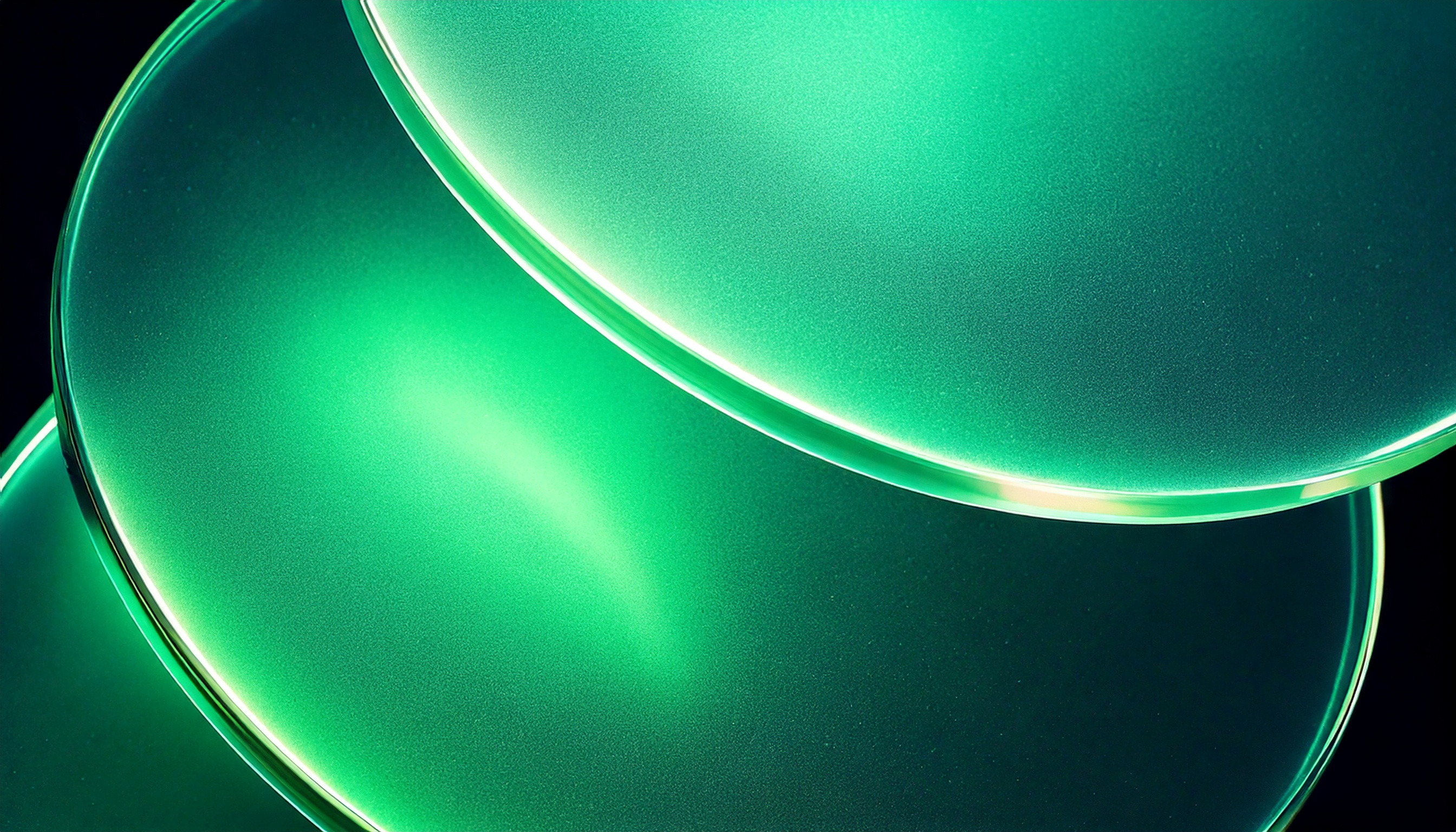 Stacked translucent glass discs in green on a dark background