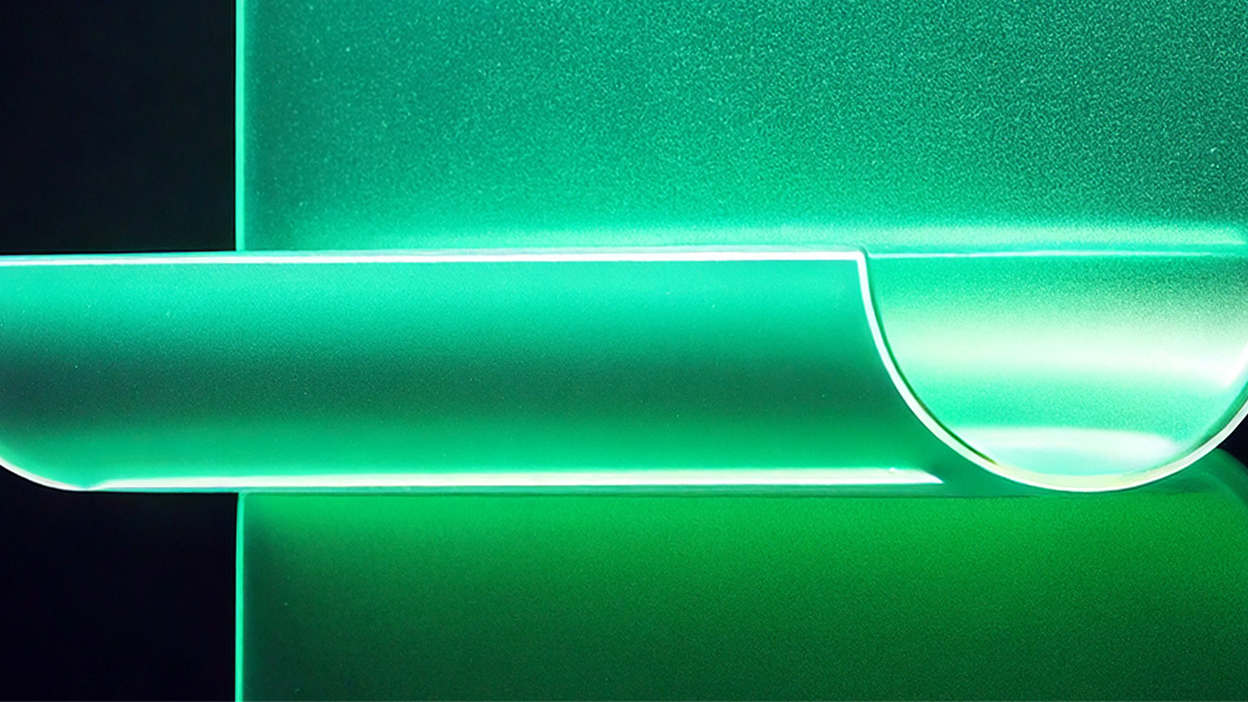 Curled translucent glass form in green evoking a scroll or unfurling page