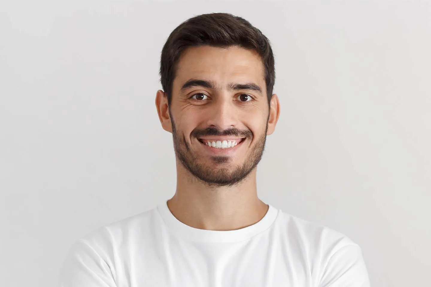 A man with a goatee smiles at the camera.