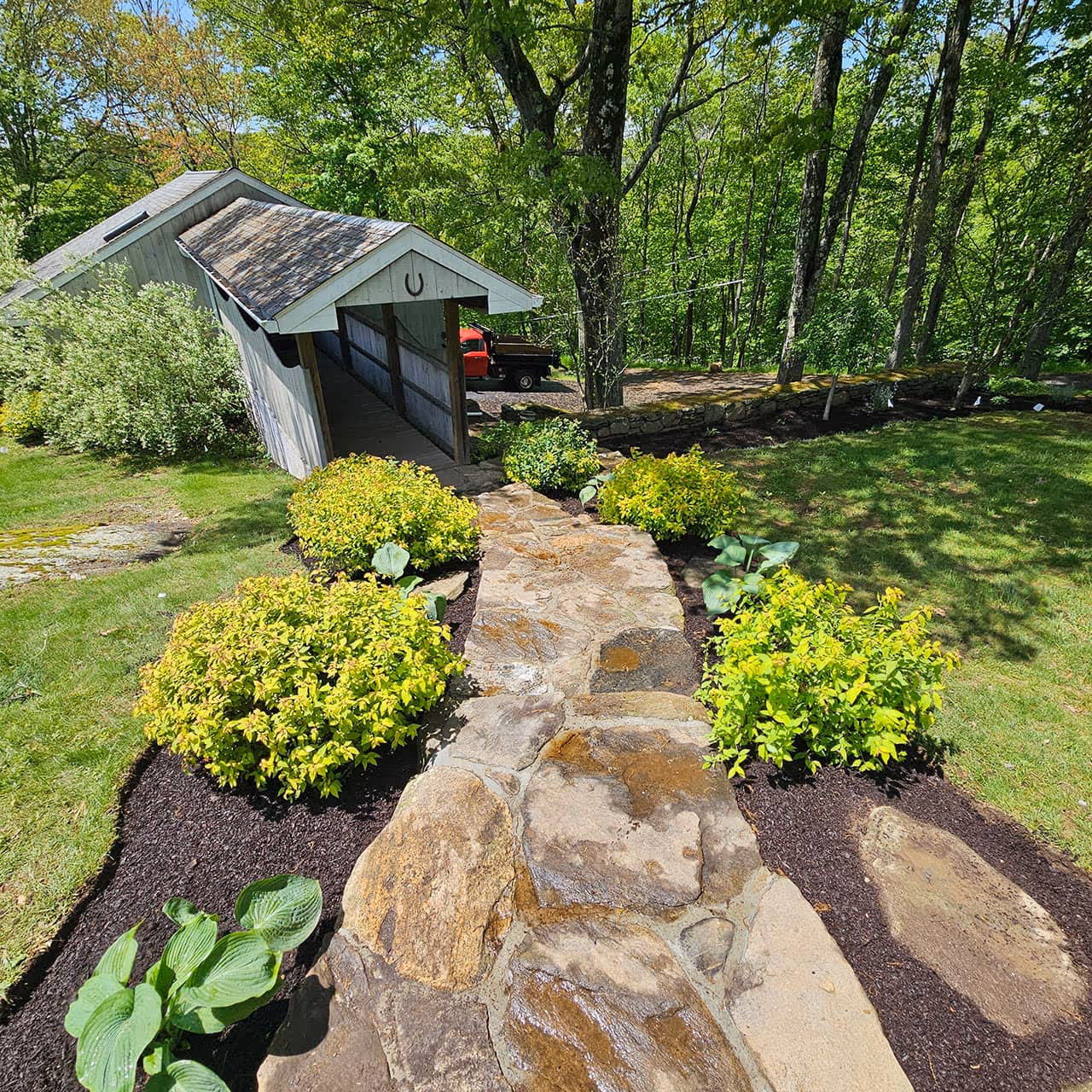 Garden planting and mulch refresh by Classic Outdoors near men