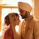 Bride and groom in traditional Indian attire posing closely together in warm light.