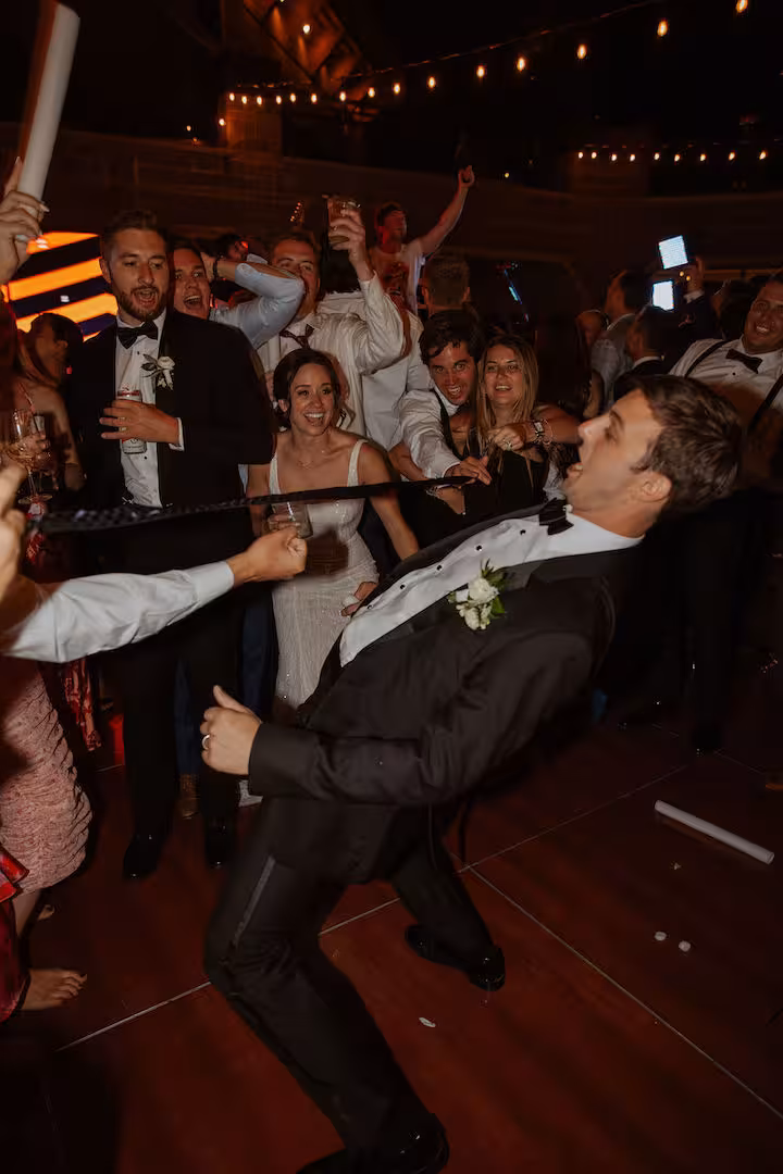 wedding groom performing limbo at his wedding