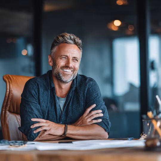 Business Owner sitting at a desk smiling