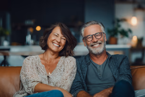 Couple smiling on a couch