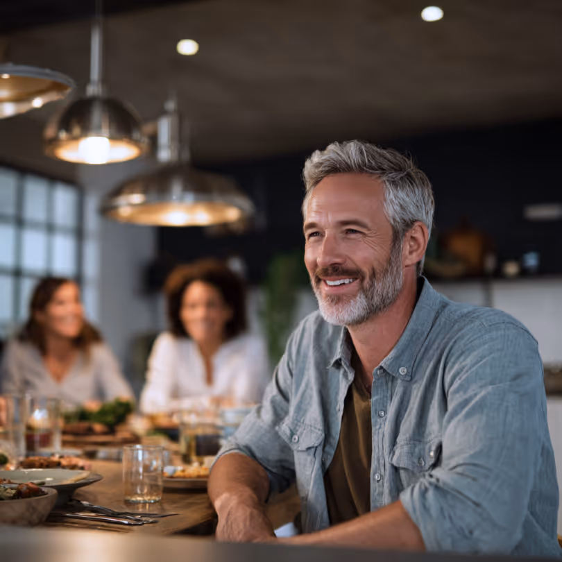 Man at dinner table with his family