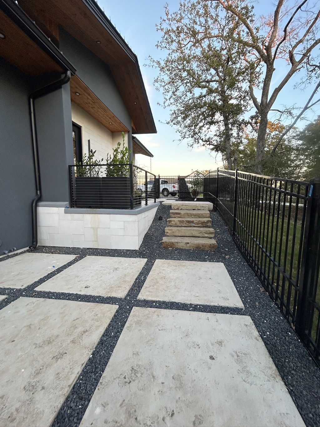 Corner view of luxury brick and stone home with new shingle roof in Southlake TX
