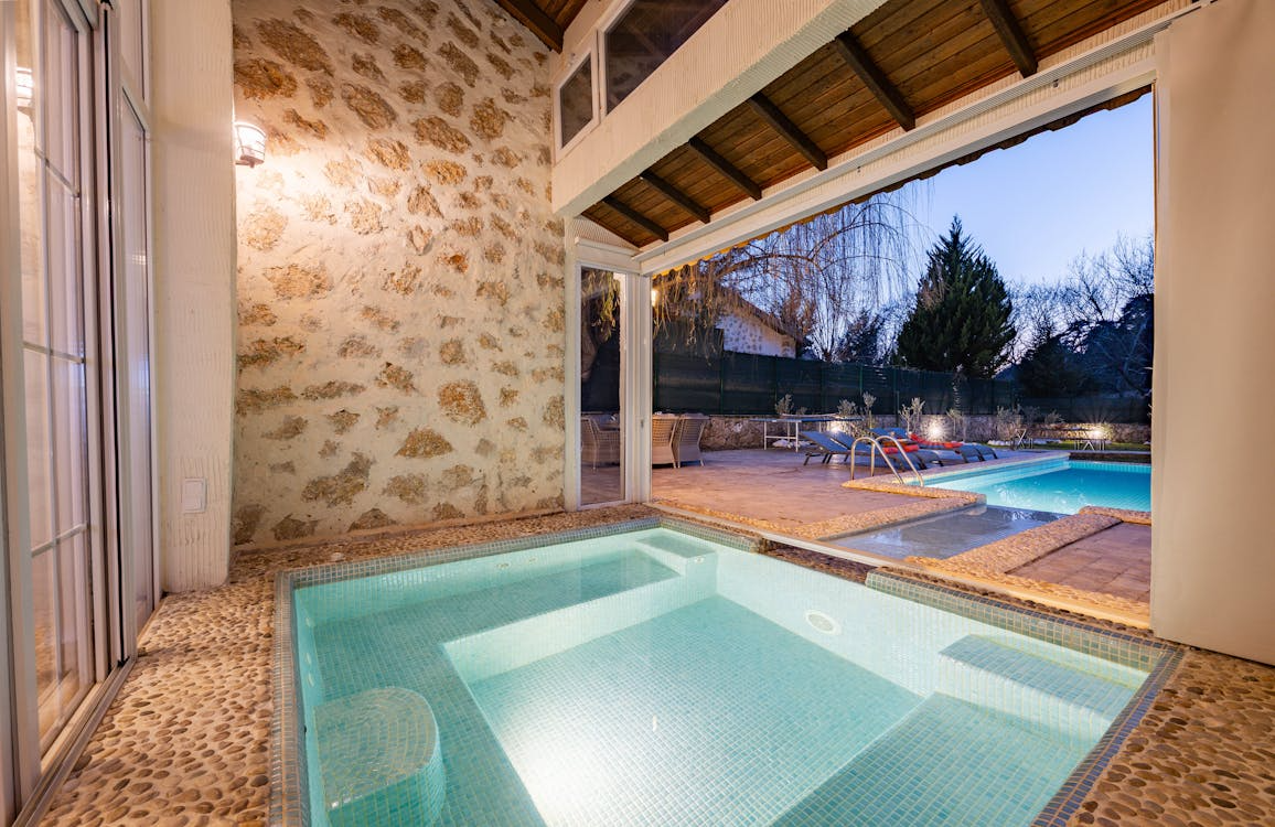 Two-story stone home with newly installed asphalt roof in Southlake TX