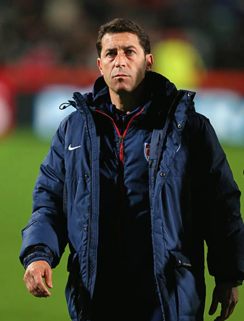 Tab Ramos in a heavy winter coat with USA Soccer crest walking.