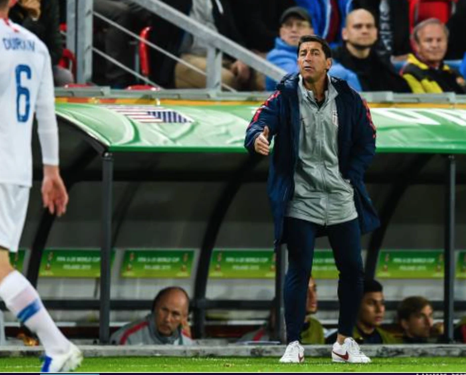 Tab Ramos in USA Men's Soccer Coaching attire giving instruction from sideline to players.